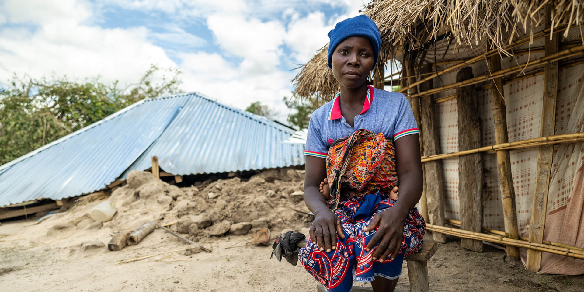 Frau vor zerstörtem Haus in Mosambik nach Tropensturm 'Freddy'